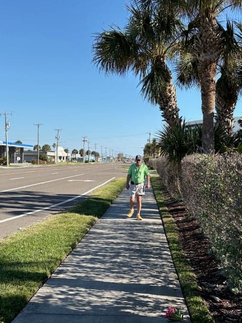 Aaron walking on a sidewalk in Florida.